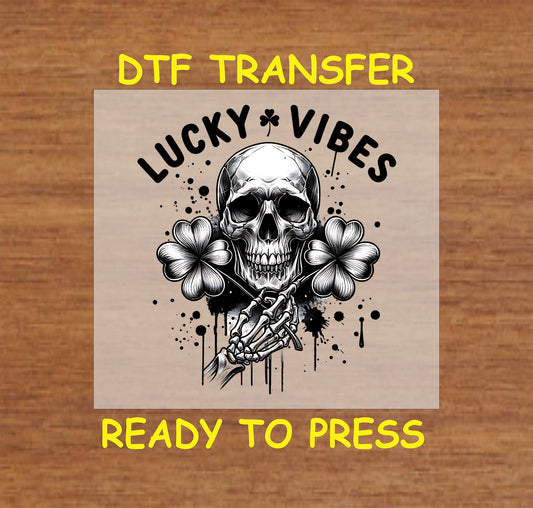 Black-and-white skull with crossed skeletal hands and shamrocks.