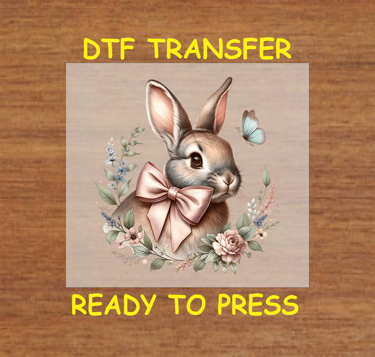 Vintage-style bunny with a satin bow, surrounded by soft florals and a butterfly.