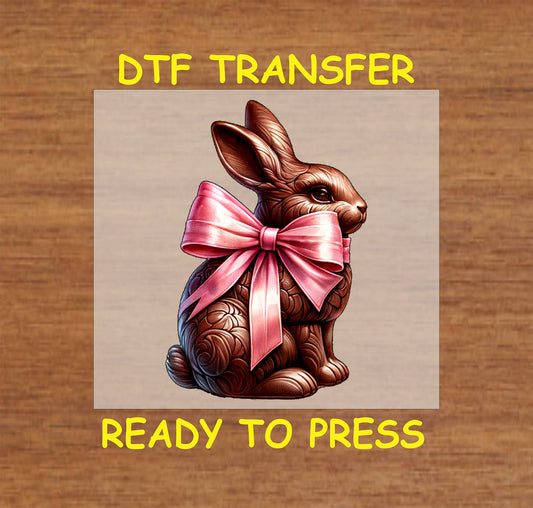Decorative chocolate bunny with a pink satin bow, ideal for Easter apparel.