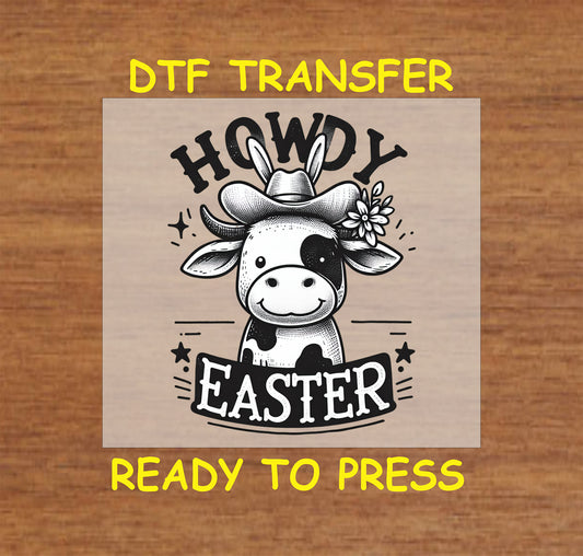 Black and white cow wearing a cowboy hat with bunny ears and “Howdy Easter” text.