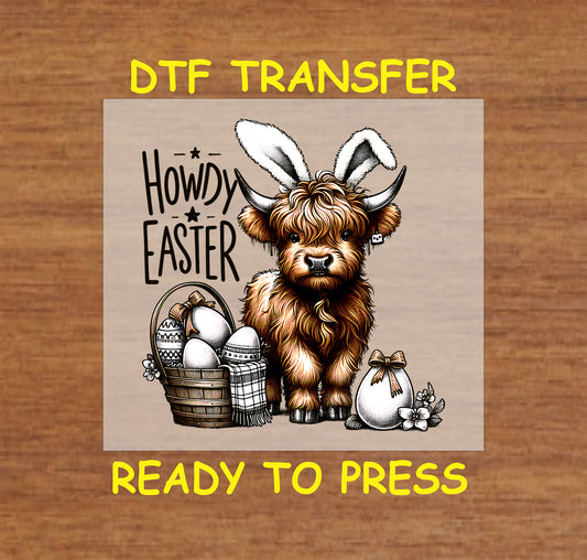 Highland cow wearing bunny ears with "Howdy Easter" text and a basket of eggs.