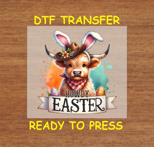 Highland cow wearing bunny ears and a cowboy hat with "Howdy Easter" text and decorative eggs.