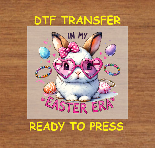 Cute bunny wearing pink heart sunglasses, a bow, and surrounded by Easter eggs and bracelets.