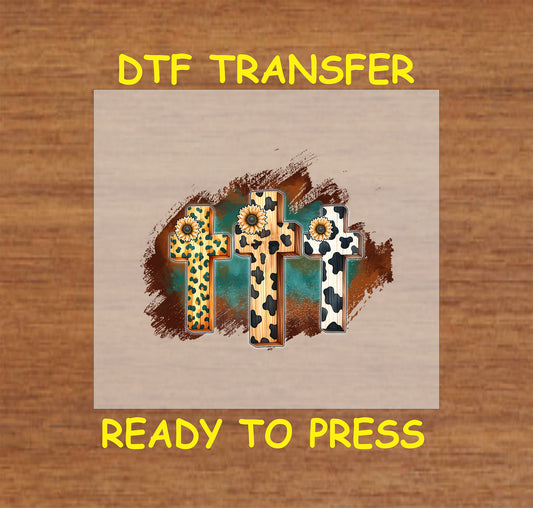 Western-style DTF transfer with three crosses in leopard, cow print, and wood grain with sunflowers.