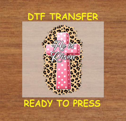 Pink polka dot cross with "He Is Risen" text on a leopard print background.