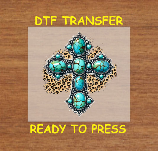 Ornate turquoise cross with silver accents over a leopard print background.