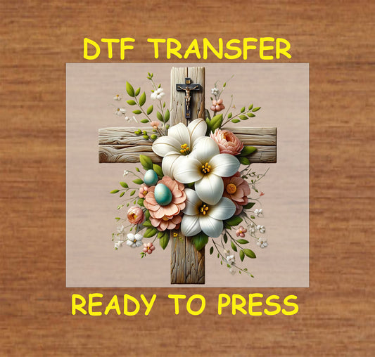 Rustic wooden cross with soft white and peach flowers, pastel eggs, and a crucifix.