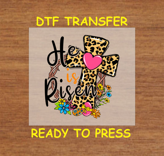 Leopard cross He Is Risen Easter DTF transfer with flowers, heart, and eggs.