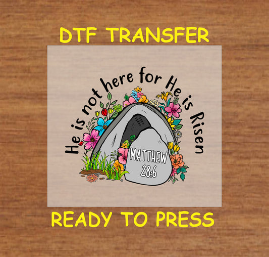 He Is Risen Easter DTF transfer with an empty tomb, flowers, and Matthew 28:6 verse.