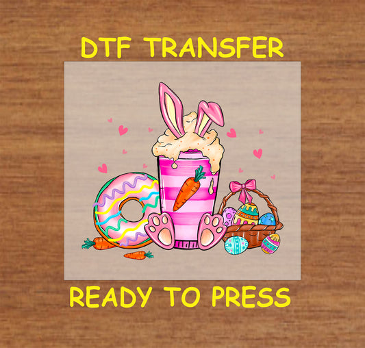 Easter Bunny Drink DTF transfer with a pink whipped drink, bunny ears, donut, carrots, and an Easter basket.