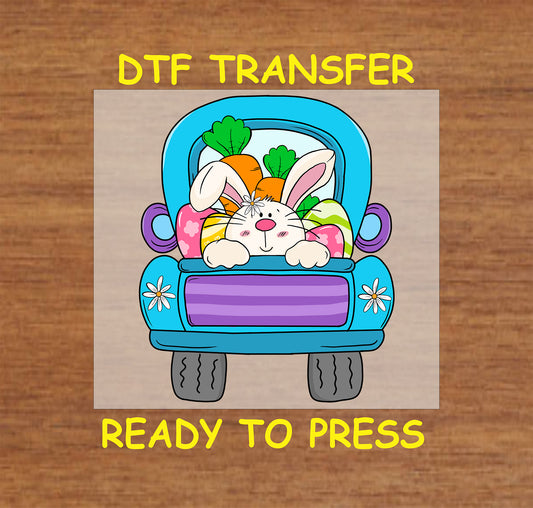 DTF transfer of a bunny in a blue truck carrying Easter eggs and carrots.