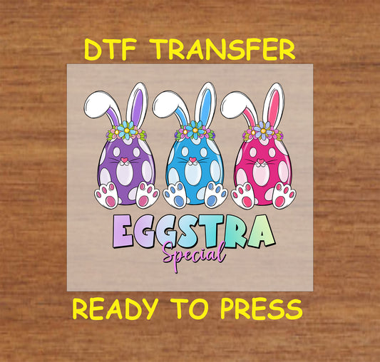 DTF transfer featuring three polka-dot bunnies in purple, blue, and pink with floral crowns and "Eggstra Special" text.