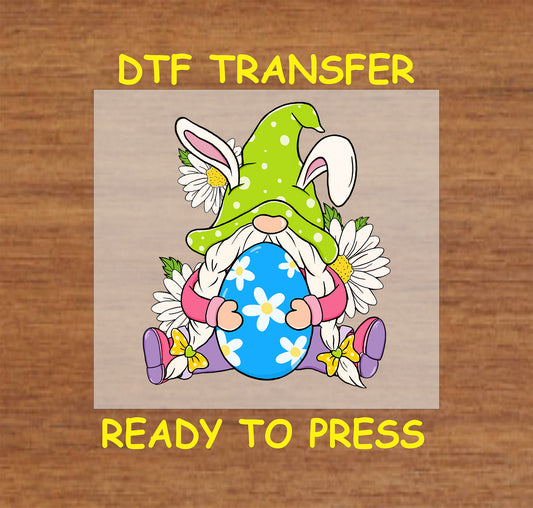 DTF transfer of an Easter gnome wearing bunny ears, holding a blue floral egg, surrounded by daisies.