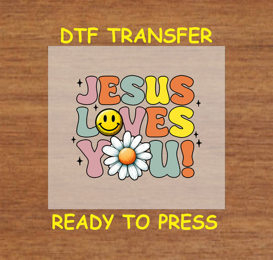 Retro-style "Jesus Loves You" DTF transfer with a daisy and smiley face.