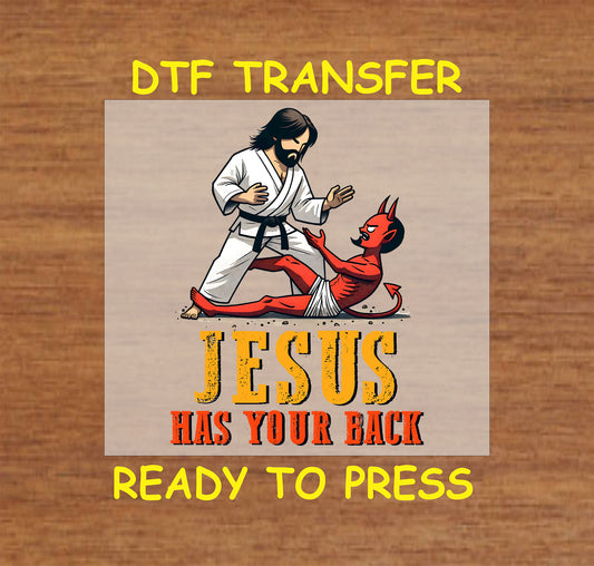 Jesus in a martial arts stance overpowering a red devil, with "Jesus Has Your Back" text.