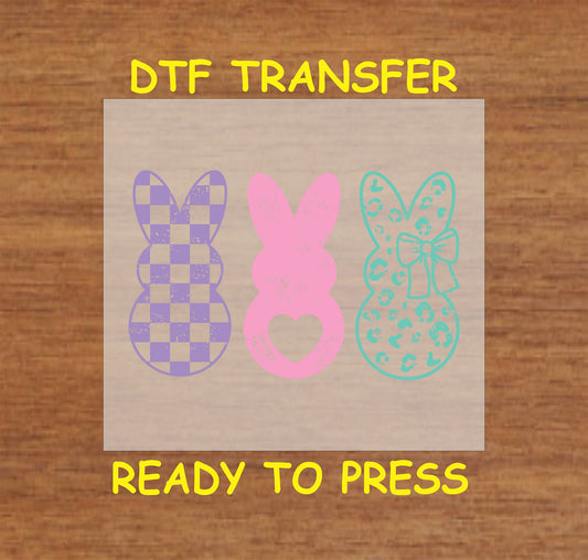 Three pastel bunnies in checkered, heart cutout, and leopard print designs.