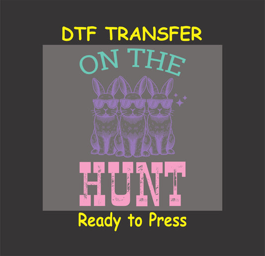 Three bunnies wearing sunglasses with "On the Hunt" text in pastel colors.