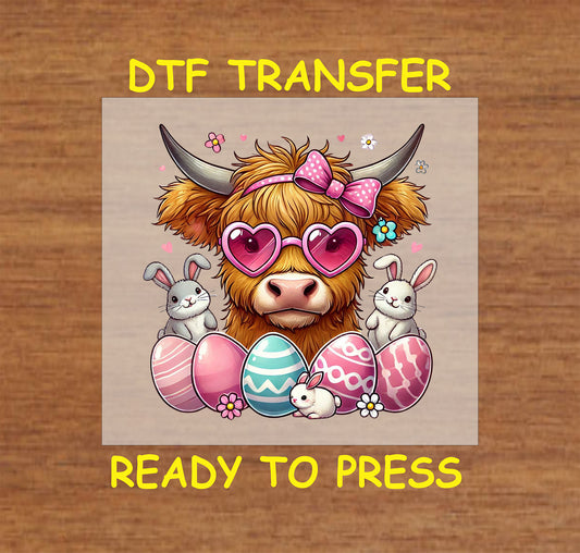 Highland cow wearing heart sunglasses with Easter bunnies and decorated eggs.