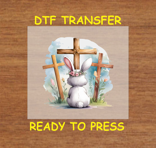 Easter Bunny and Crosses DTF Transfer with a bunny facing three wooden crosses, floral accents, and a watercolor background.