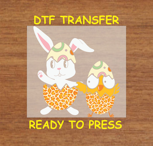 Cartoon bunny and chick hatching from patterned eggshells, Easter DTF transfer.