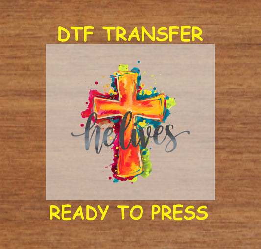 "He Lives" text with a bold watercolor cross in bright colors.