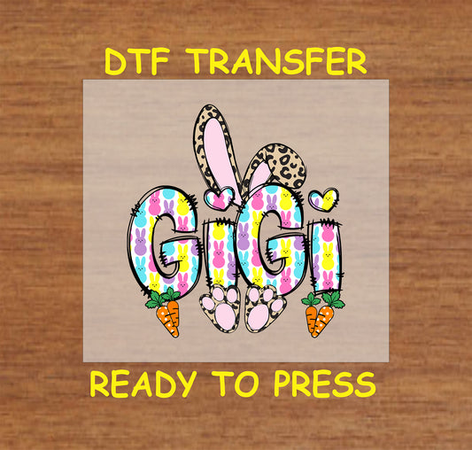 Gigi Easter Bunny DTF transfer with colorful bunny-patterned letters, leopard print bunny ears, and carrots.