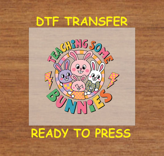 Teaching Some Bunnies DTF transfer with colorful bunnies, retro text, and a fun Easter school theme.