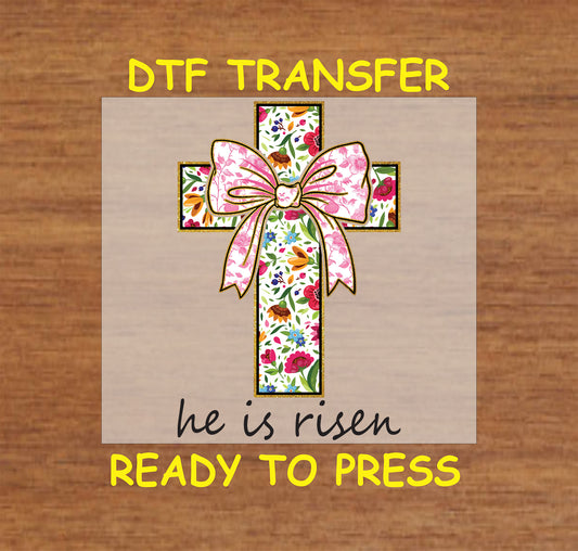 Floral-patterned cross with pink bow and "He Is Risen" text DTF transfer for Easter.
