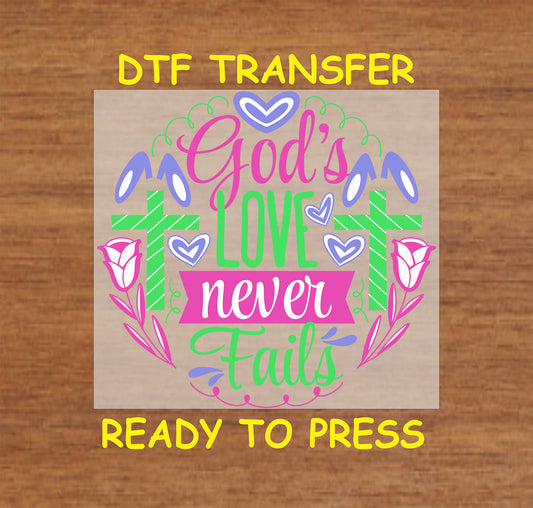 God's Love Never Fails DTF transfer with two crosses, flowers, and Easter accents.