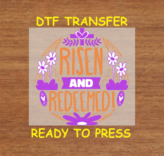 Risen and Redeemed DTF transfer with a cross, flowers, and heart details in a faith-based Easter design.