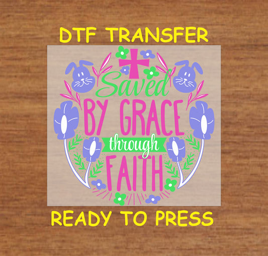 Saved by Grace Through Faith DTF transfer with a cross, flowers, and bunny accents in a faith-based Easter design.