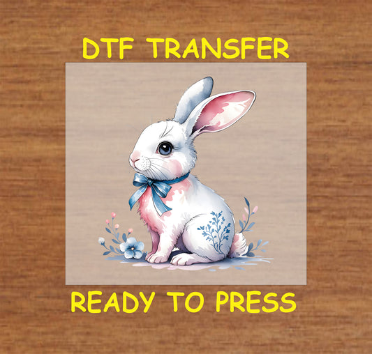 White Easter bunny DTF transfer with floral accents and a blue bow.