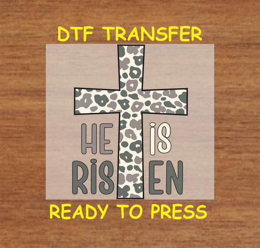 Leopard print cross with He Is Risen text, Easter faith design.
