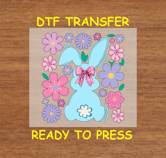 Blue bunny silhouette with a pink bow surrounded by pastel flowers.