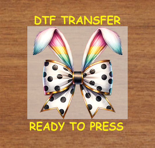Polka dot bow with rainbow bunny ears in a stylish Easter-themed design.