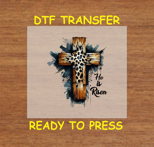 He Is Risen DTF transfer with a rustic wooden cross and leopard print details.