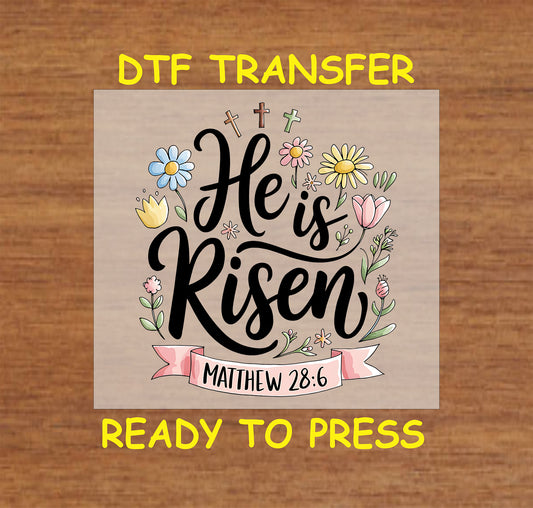 He Is Risen DTF transfer with Matthew 28:6 Bible verse, floral accents, and crosses.