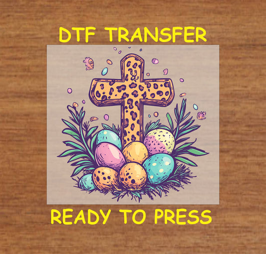 Leopard print cross DTF transfer with colorful Easter eggs and greenery.