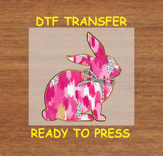 Pink patterned bunny DTF transfer with gold and white accents and a bow.