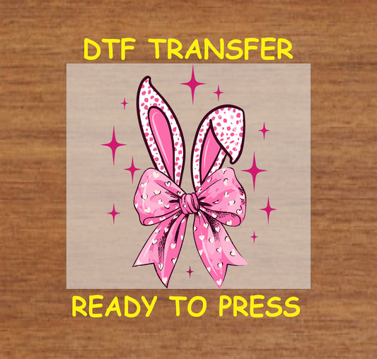Easter DTF transfer with pink bunny ears, a bow, and heart details on a pastel background.