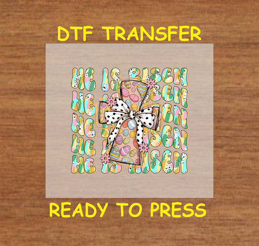 Cross with Easter eggs, flowers, and "He Is Risen" text in a colorful pattern.