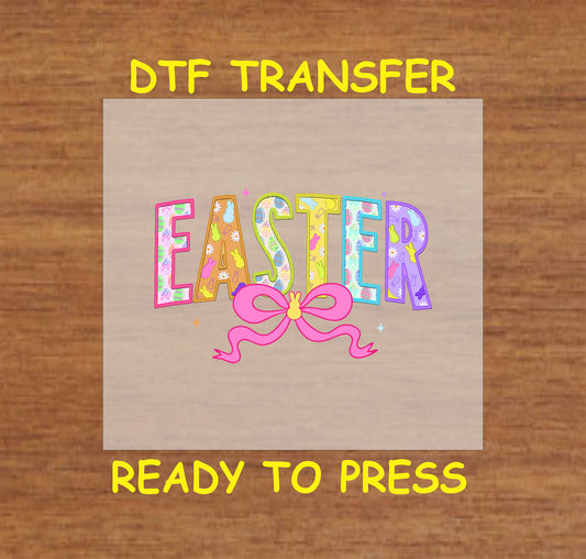 Multicolored "Easter" DTF transfer with bunnies, eggs, and a pink bow.
