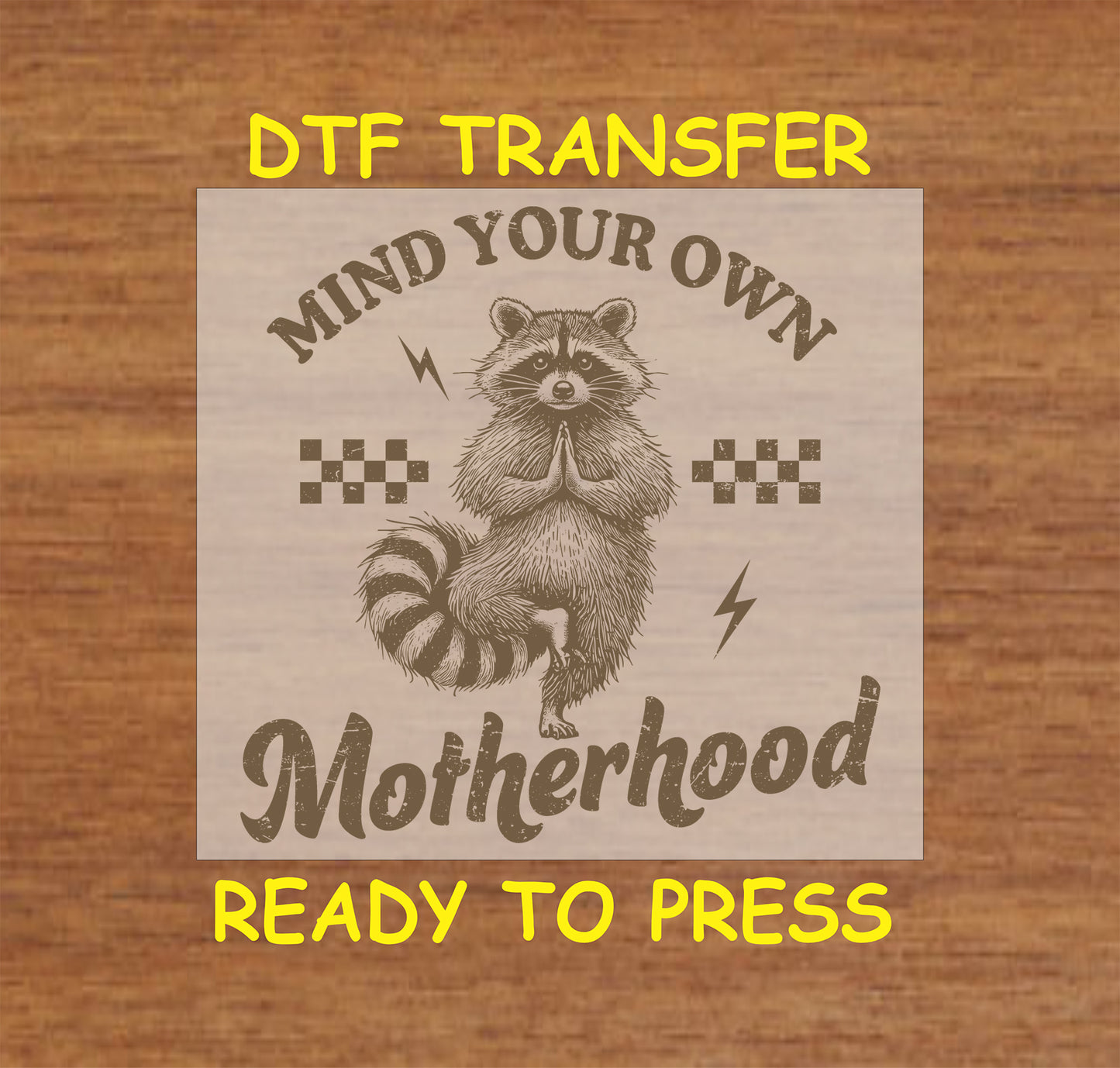 Mind Your Own Motherhood DTF transfer with a meditating raccoon, retro checkers, and lightning bolts.