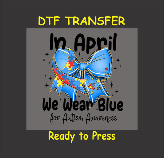 Autism Awareness DTF transfer with a blue bow and puzzle ribbon, text "In April We Wear Blue."