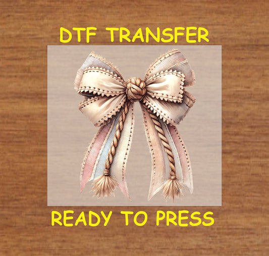 Rustic Western-style bow with rope and stitched fabric ribbons.