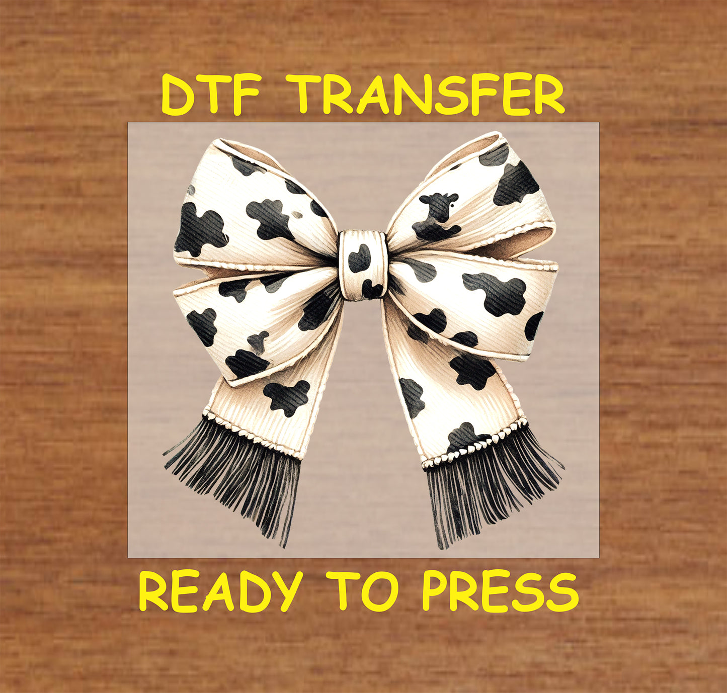 Cow print bow with stitched details and black fringe accents.