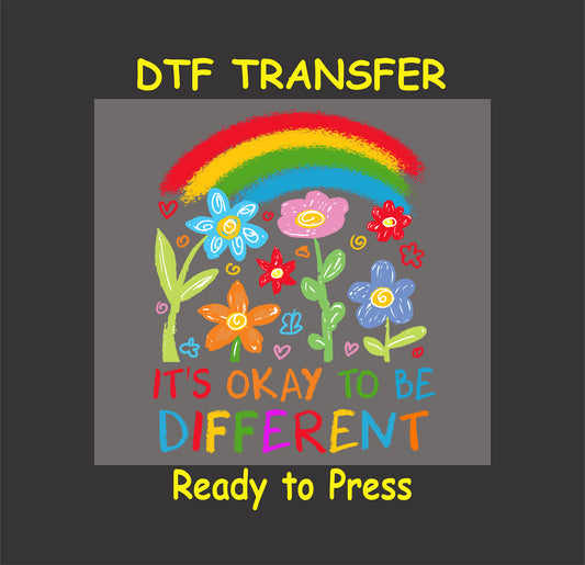 It’s Okay to Be Different DTF transfer with a rainbow, colorful flowers, and motivational message.