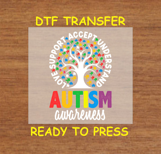 Tree with puzzle pieces and autism awareness words in rainbow colors.