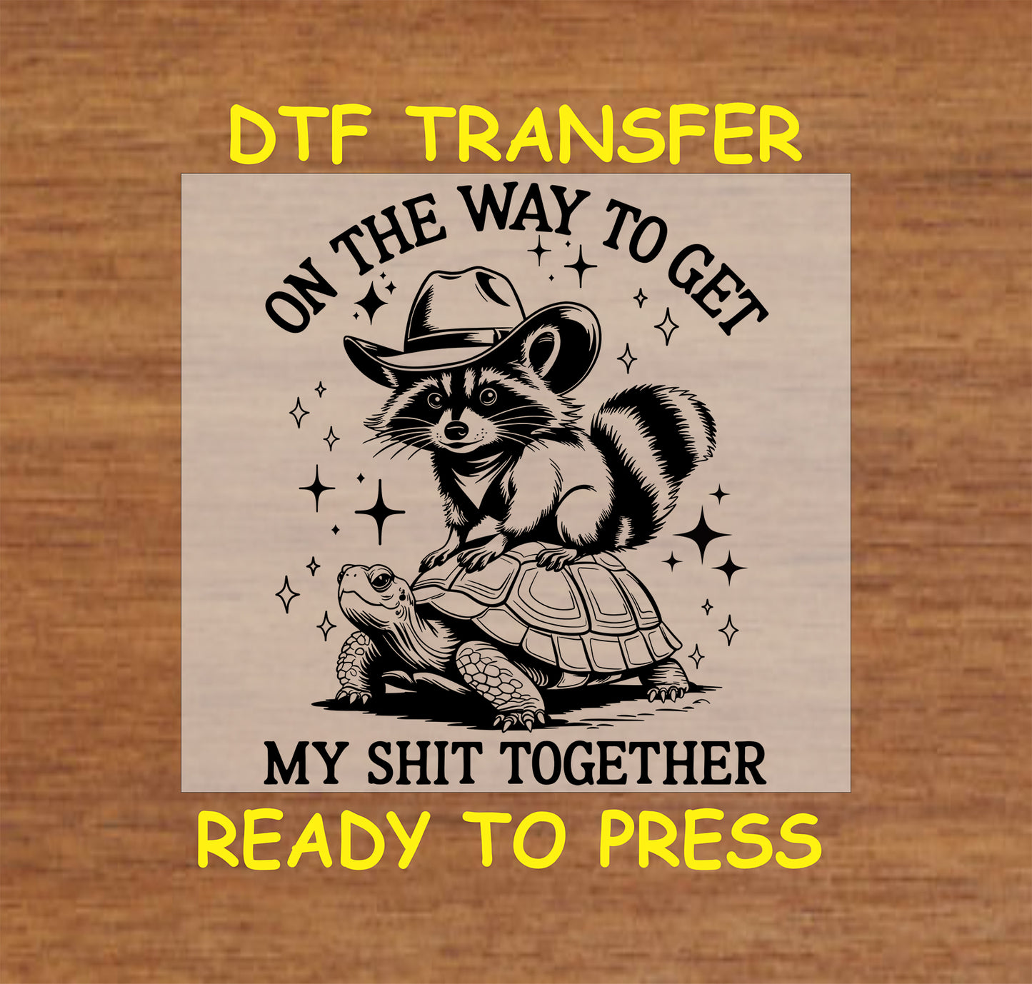 DTF transfer of raccoon in cowboy hat riding a turtle with funny quote about getting life together.