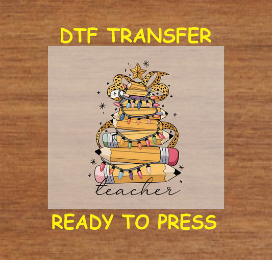 Teacher Christmas tree made of books and pencils with lights and leopard ribbon.